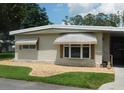 Charming home features decorative window shades and rock border landscaping at 146 Hibiscus Way, Leesburg, FL 34748