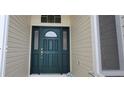 Elegant front door with decorative glass panel and sidelights at 1550 Ward Ct, The Villages, FL 32162