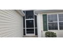 Screened front porch with storm door creates a welcoming entrance to the home at 1550 Ward Ct, The Villages, FL 32162