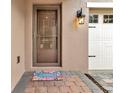 Close-up of the front door showing the welcoming entrance and neat landscaping leading up to the home at 15531 Waterleigh Cove Dr, Winter Garden, FL 34787