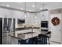 Modern kitchen with stainless steel appliances, granite countertops, and a stylish island with bar seating at 1640 Marsh Pointe Dr, Clermont, FL 34711