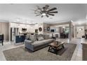 Open-concept living room featuring a comfortable sofa, stylish decor, and seamless flow into the kitchen and dining area at 1640 Marsh Pointe Dr, Clermont, FL 34711