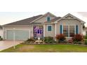 Beautiful home featuring a well-manicured lawn and garden decor at 1676 Van Buren Way, The Villages, FL 32162