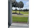 Relaxing screened-in back porch with golf course view at 1706 Augustine Dr, The Villages, FL 32159