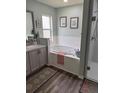 Bright bathroom featuring a soaking tub, and a separate walk-in shower at 1706 Augustine Dr, The Villages, FL 32159