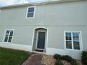 Gray two-story home with a dark front door and brick walkway at 212 Primrose Dr, Davenport, FL 33837
