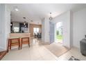 Inviting foyer leading into a well-lit home with tiled floors and an open layout at 212 Primrose Dr, Davenport, FL 33837
