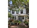 Front exterior of a multi-Gathering home with a shared entrance surrounded by many potted plants at 220 E Woodward Ave, Eustis, FL 32726