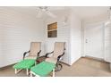 Covered porch featuring two chairs with ottomans and a ceiling fan at 2317 Whisper St, The Villages, FL 32162