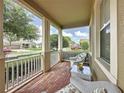 Cozy front porch with wicker furniture, ideal for relaxing and enjoying the neighborhood view at 243 Bayou Bend Rd, Groveland, FL 34736