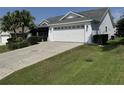 Exterior of the property showcasing a paved driveway with a star design and well-maintained landscaping at 2530 Hanlon Ter, The Villages, FL 32162