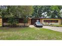 Single-story home with stone accents and large front yard at 2707 Woodbridge Ln, Orlando, FL 32808