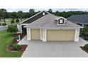 Attractive home featuring a two-car garage, landscaped yard, and neutral tones at 3466 Smedley Rd, The Villages, FL 32163