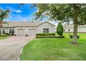 Charming home features a two-car garage, well-manicured lawn, and neat shrubbery at 3547 Fairwaters Ct # F, Clermont, FL 34711