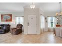 Inviting foyer with tile flooring, neutral walls, and a stylish front door with sidelight windows at 3547 Fairwaters Ct # F, Clermont, FL 34711
