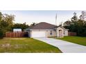 Single-story home features a private backyard, attached two-car garage and lengthy driveway at 4002 Sw 158Th Street Rd, Ocala, FL 34473