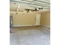 Spacious garage with overhead storage racks, door to the house, and an electric water heater at 4002 Sw 158Th Street Rd, Ocala, FL 34473