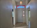 Inviting home foyer featuring tile flooring, a decorative transom window, and adjacent rooms at 5436 Astor St, Leesburg, FL 34748