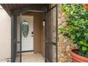 Screened entry with stone accents leads to the front door featuring decorative glass insert at 721 Mendoza Dr, Orlando, FL 32825