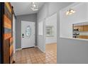 Inviting foyer with tile flooring and a sliding barn door adds character at 721 Mendoza Dr, Orlando, FL 32825