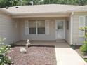 Welcoming front porch with decorative elements, perfect for enjoying a quiet moment outdoors at 8377 Se 177Th Bartram Loop, The Villages, FL 32162