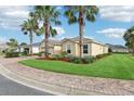 Inviting single-story home boasts a brick driveway, meticulous landscaping, and a convenient two-car garage at 10046 Ketch Kay Ln, Oxford, FL 34484