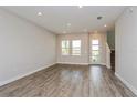 Spacious living room with luxury vinyl plank flooring, recessed lighting, and a modern entryway at 10302 Pearson Ave, Orlando, FL 32827