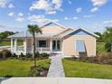 Beautiful single-story home with a welcoming porch and a neatly manicured front lawn at 1042 Sugarloaf Key Loop, Lady Lake, FL 32159