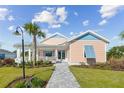 Inviting single-story home boasts a charming porch and well-kept front yard landscaping at 1042 Sugarloaf Key Loop, Lady Lake, FL 32159