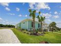 Well-maintained home boasting a serene front yard, complemented by lovely palm trees and a brick-paved driveway at 1057 Sugarloaf Key Loop, Lady Lake, FL 32159