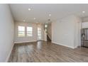 Open-concept living space with modern finishes, hardwood floors, and staircase at 1065 Peebles St, Orlando, FL 32827