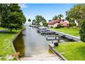 Community boat dock with several boat slips offering convenient water access for residents at 112 Waterwood Dr, Yalaha, FL 34797