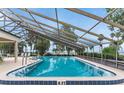 Enclosed pool with clear blue water, great for year-round enjoyment and relaxation at 112 Waterwood Dr, Yalaha, FL 34797