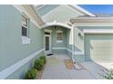 Welcoming front entrance with decorative accents and manicured landscaping, creating great curb appeal at 1122 Magrath Way, The Villages, FL 32162