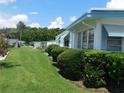 Well-maintained exterior view showcasing lush green lawn, tidy landscaping, and serene surroundings at 114 Azalea Trl, Leesburg, FL 34748