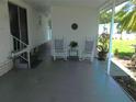 Relaxing covered patio with rocking chairs, offering a peaceful outdoor living space at 114 Azalea Trl, Leesburg, FL 34748