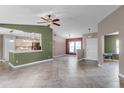 Open-concept living area with tile floors, stylish lighting, and a view into the kitchen at 15916 Indian Wells Ct, Clermont, FL 34711
