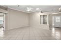 Open-concept living room with tile floors, ceiling fan, and a glimpse of the front entrance at 2104 Gerardo Ave, Lady Lake, FL 32159