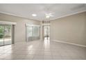 Spacious living room with tile flooring, a ceiling fan, and sliding glass doors leading to the outdoors at 2104 Gerardo Ave, Lady Lake, FL 32159