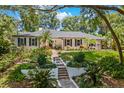 Inviting single-story home boasting a meticulously maintained front yard with garden and stone walkway at 2214 Dogwood Cir, Mount Dora, FL 32757