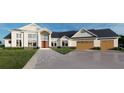 Charming home showcasing a blend of stone accents, a welcoming entryway, and a three-car garage under a blue sky at 2421 Shady Ln, Groveland, FL 34736