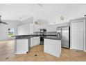 Bright kitchen features stainless steel appliances, pendant lighting, and an island perfect for cooking and entertaining at 2705 Bayview Dr, Eustis, FL 32726