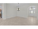 Open entryway featuring tile flooring, chandelier, and decorative front door at 2954 Heiny Pl, The Villages, FL 32163