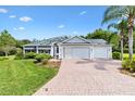 Charming single-story home featuring well-manicured landscaping and a three-car garage at 2991 Saint Thomas Ln, The Villages, FL 32162