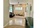 Bright living room with neutral tile floors, comfortable seating, and an abundance of natural light at 30604 Apawamis Dr, Sorrento, FL 32776
