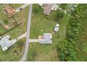 Aerial view of a home with a large yard, mature trees, and a peaceful, secluded setting at 316 Dupont Cir, Howey In The Hills, FL 34737