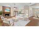 Bright living room with brick fireplace, ceiling fan, and modern furniture arrangement at 37236 Cherry Lake Rd, Fruitland Park, FL 34731