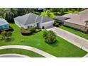 Beautiful home featuring a well manicured lawn, mature landscaping, and a long driveway that leads to a three-car garage at 3819 Saint Emma Ct, Leesburg, FL 34748