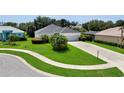 Inviting home with green lawn, mature landscaping, and a concrete driveway that leads to a three car garage at 3819 Saint Emma Ct, Leesburg, FL 34748