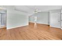 Bright, open living area with vaulted ceiling, ceiling fan, and wood flooring at 39 Pine Court Dr, Ocala, FL 34472